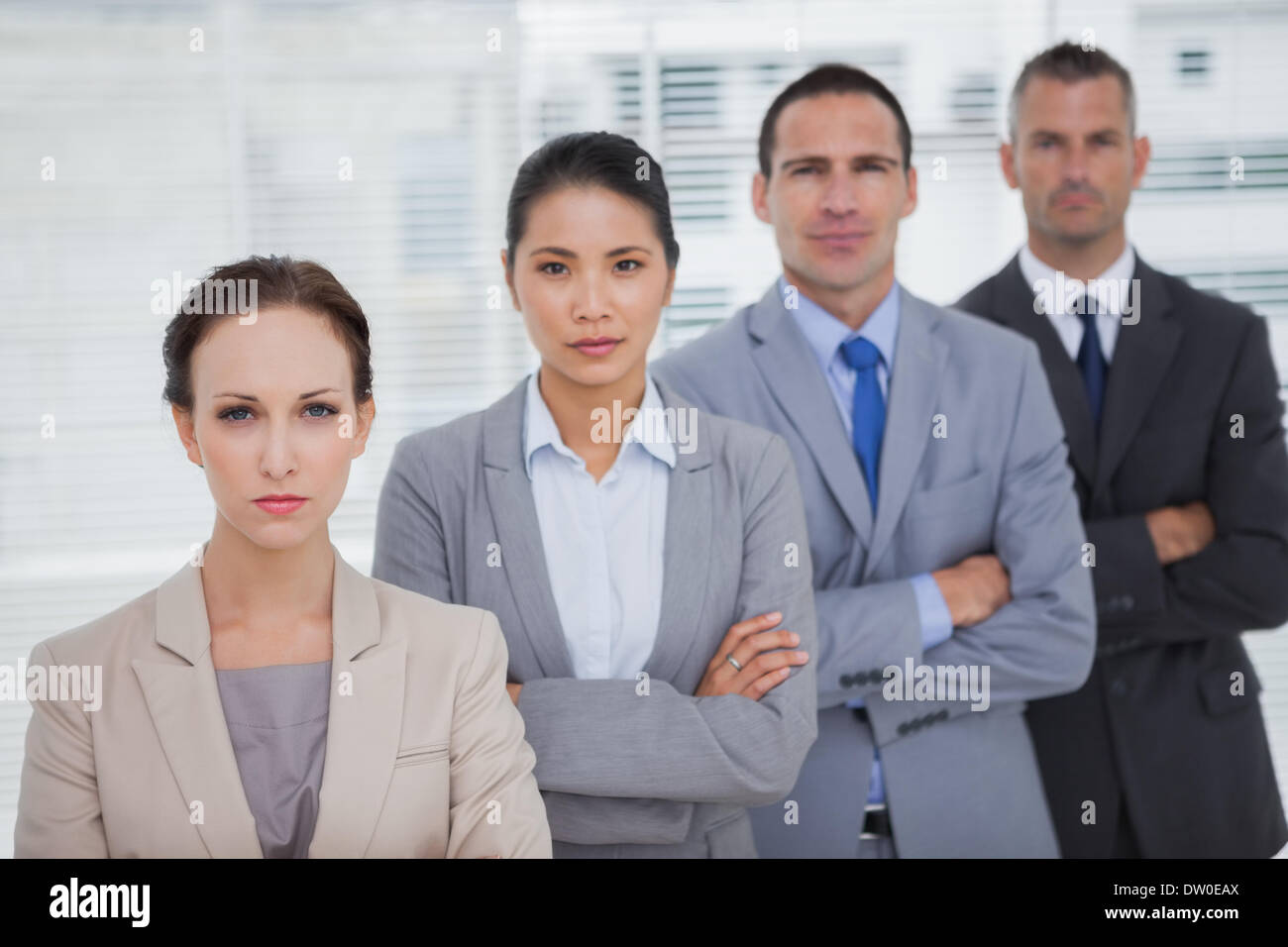 Serious business people posing crossing arms Stock Photo - Alamy
