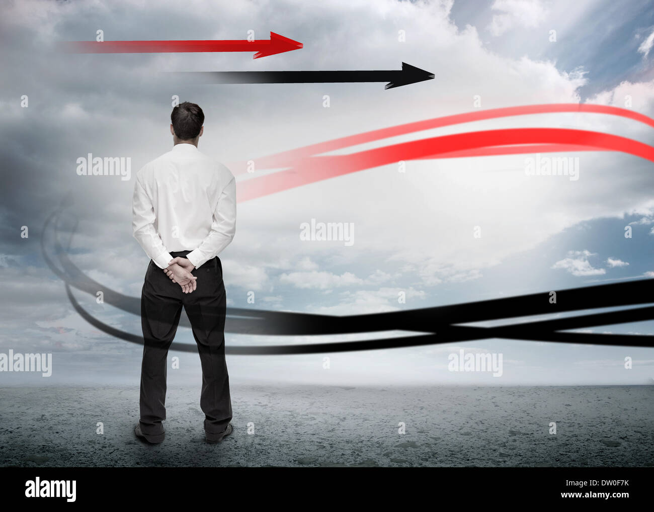 Businessman looking at red and black arrows Stock Photo - Alamy