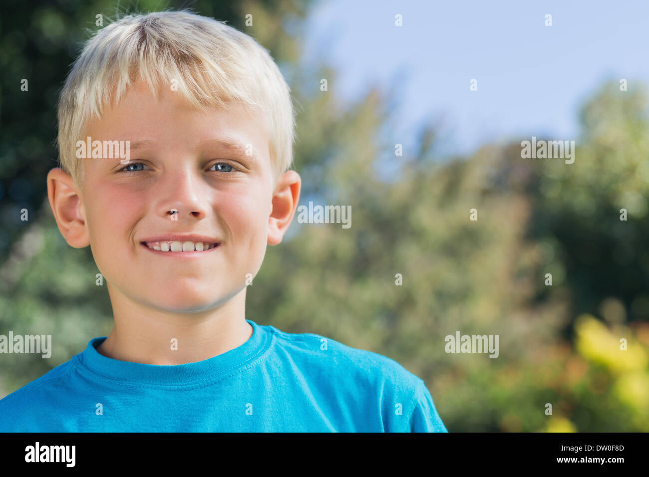 Cute blonde boy smiling at camera Stock Photo - Alamy