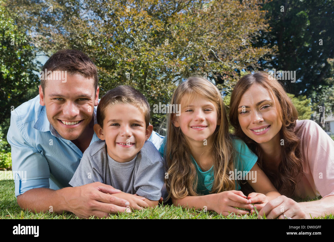 Happy family lying on ground hi-res stock photography and images - Alamy