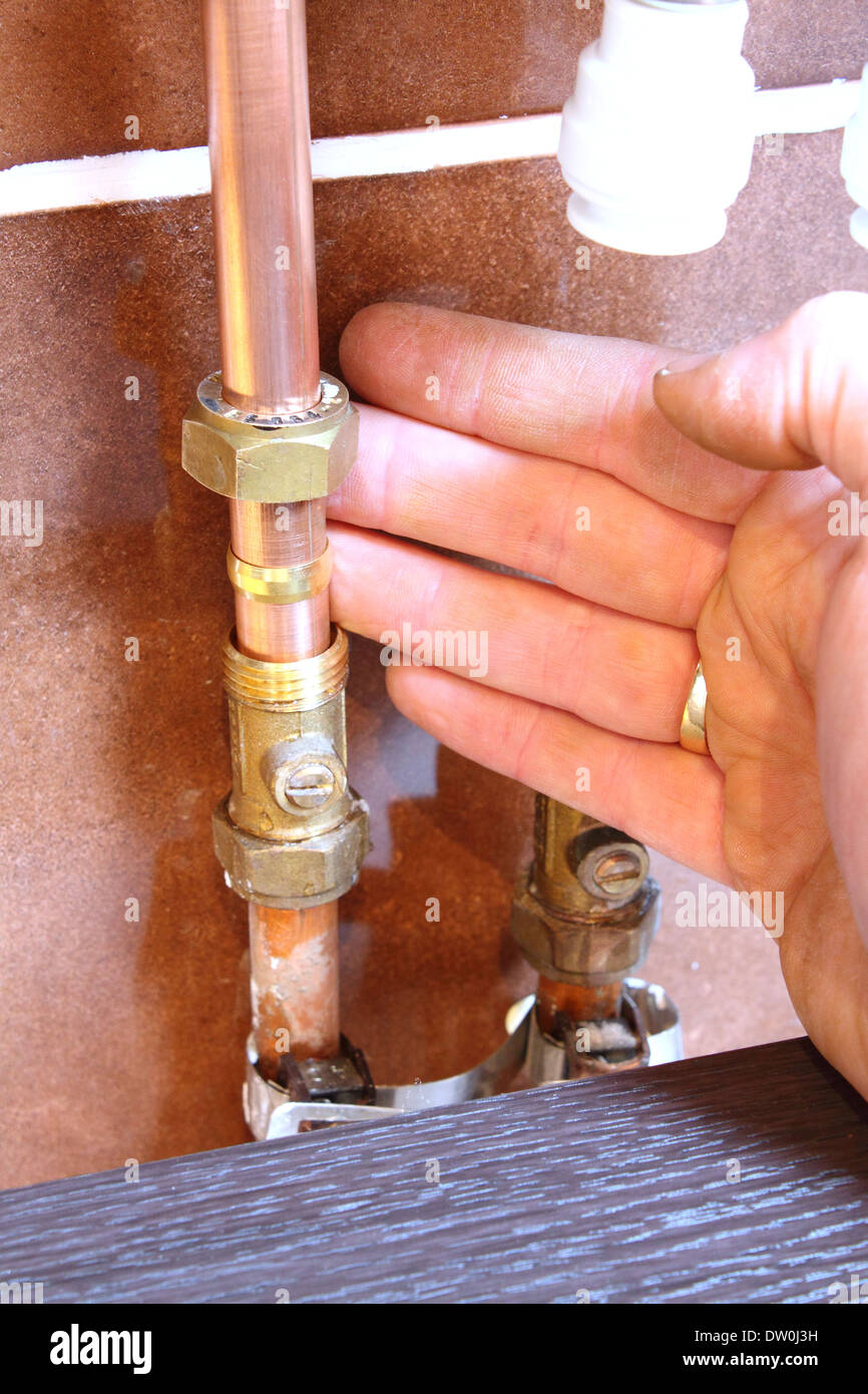 DIY plumber assembling a compression fitting for a bathroom sink Stock Photo