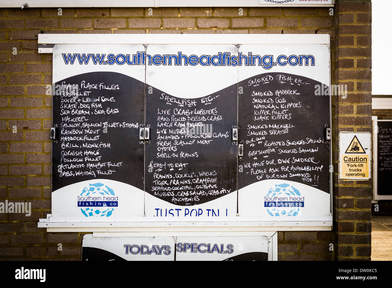 A listing of the fresh and frozen fish available at the shore-line fresh fish shop in Eastbourne East Sussex UK Stock Photo