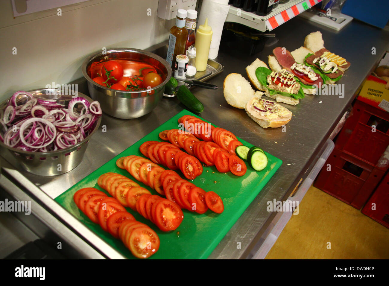 Chopped salad and vegetables on food prep area Stock Photo