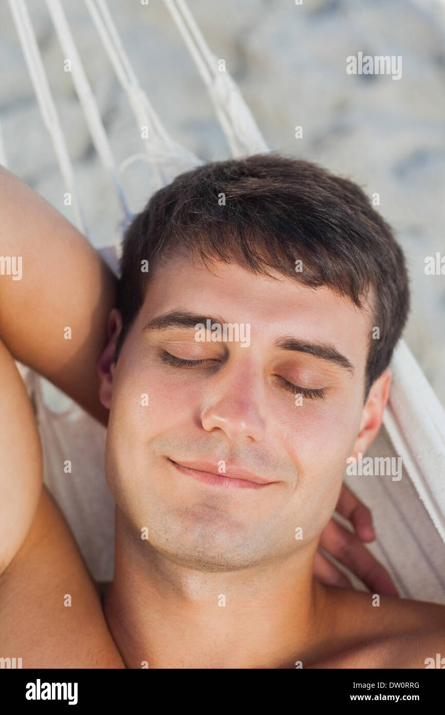 Man sleeping in hammock Stock Photo