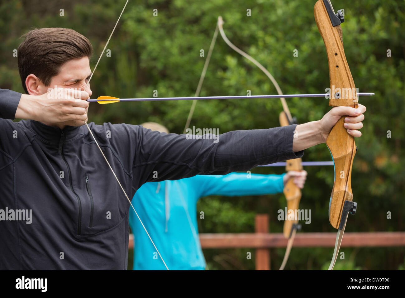 Handsome man practicing archery Stock Photo