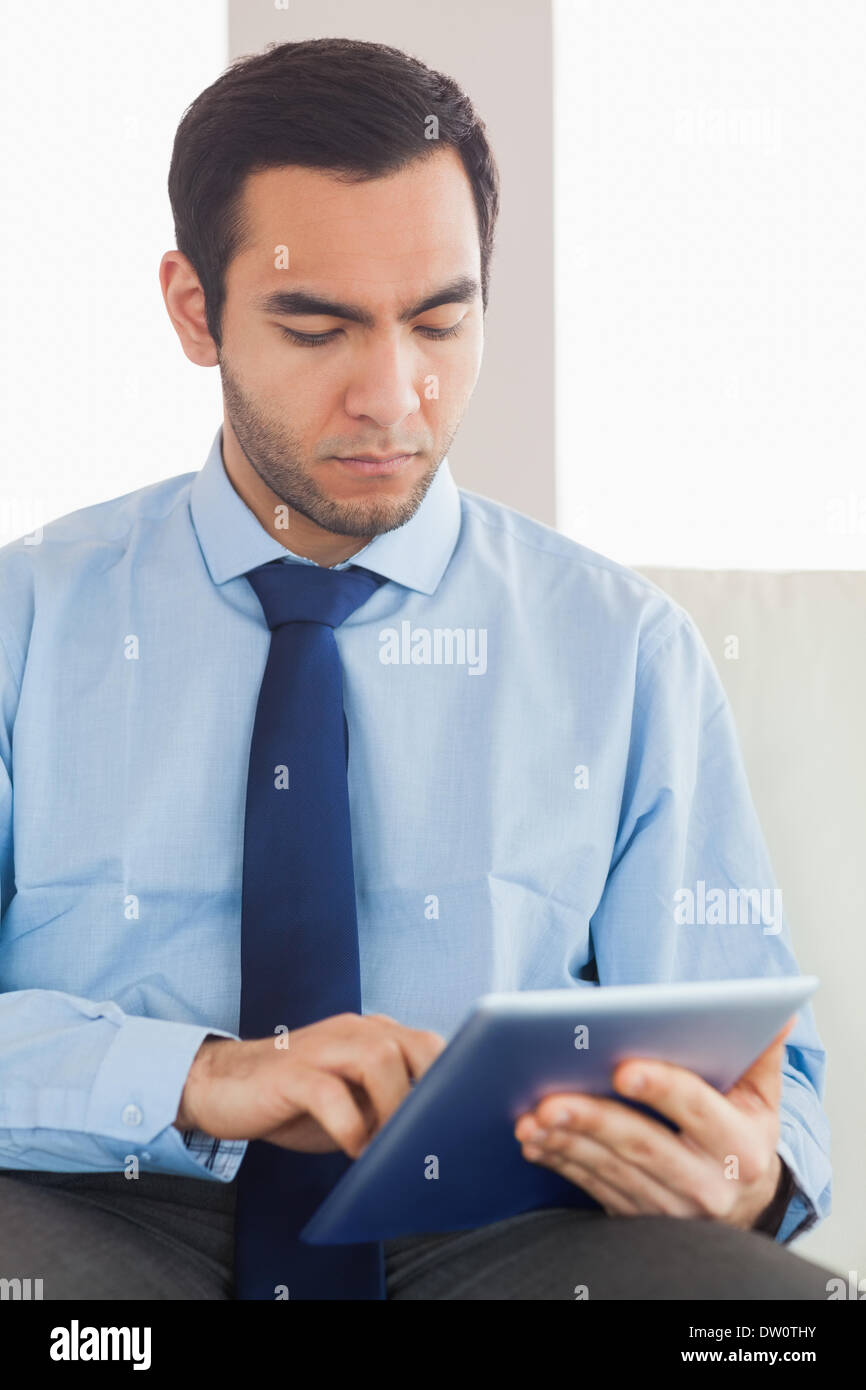 Young classy businessman using tablet pc Stock Photo