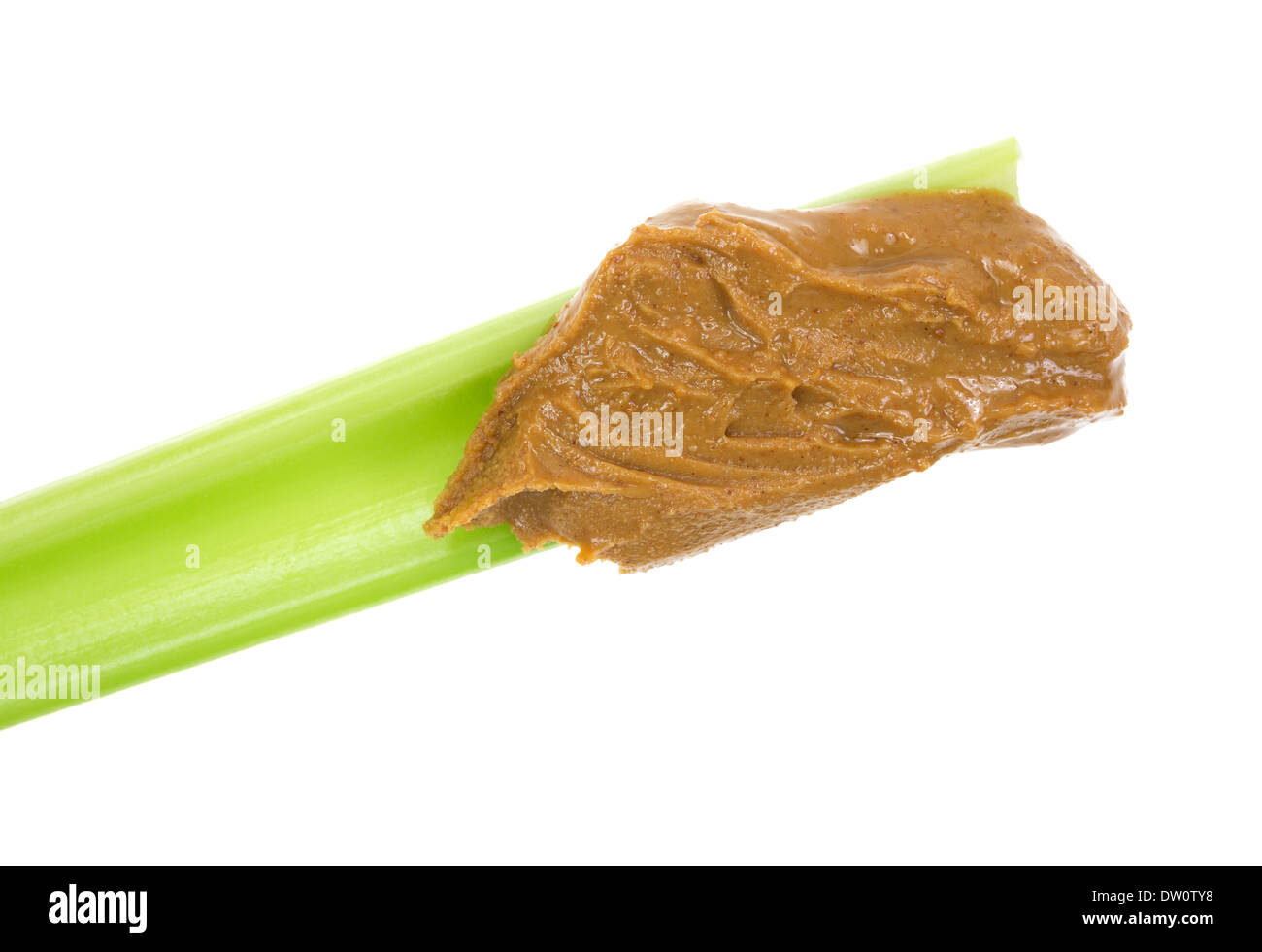 Close view of a fresh celery stalk with natural peanut butter on a