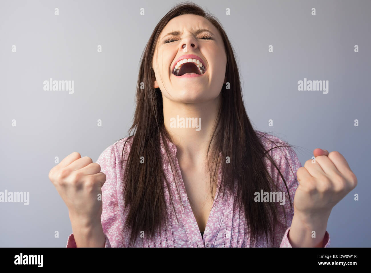Victorious classy brunette posing Stock Photo