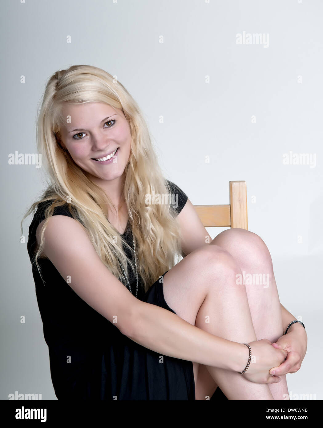happy young woman sitting Stock Photo