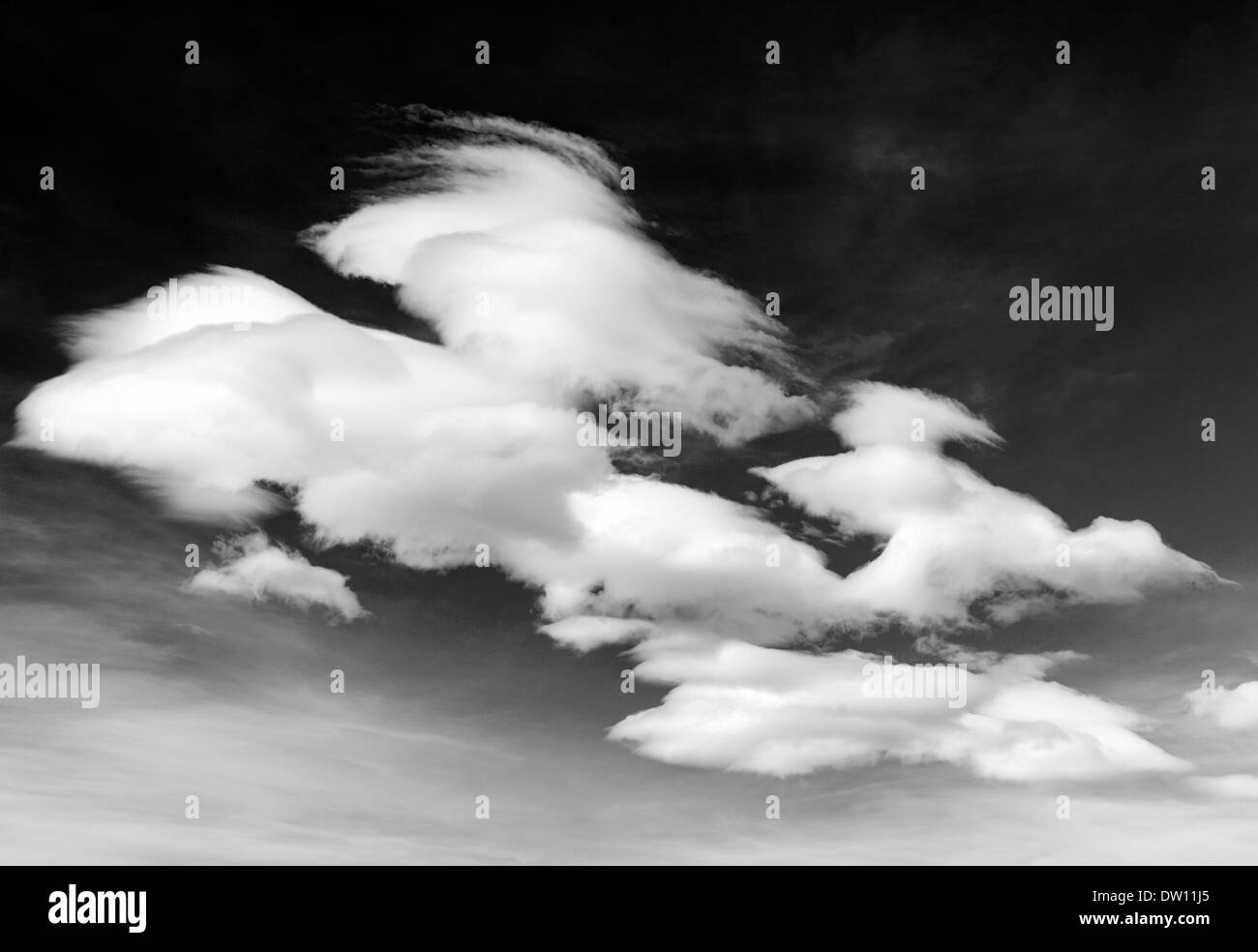 Black & white view of wispy white clouds against clear Colorado sky Stock Photo