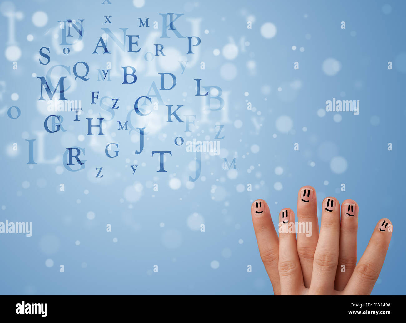 Happy smiley fingers looking at mixture of bokeh letters Stock Photo
