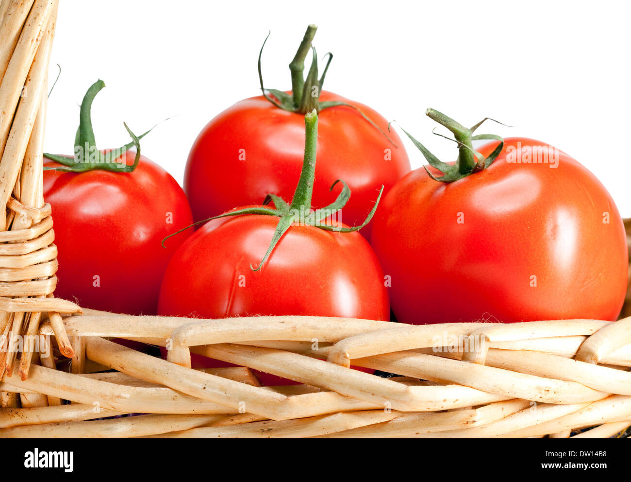 The ripened tomatoes in a wattled basket Stock Photo