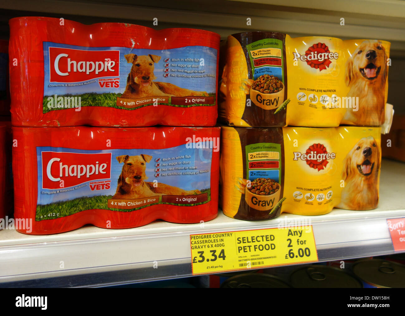 tins of dog food on shelf in a store Stock Photo