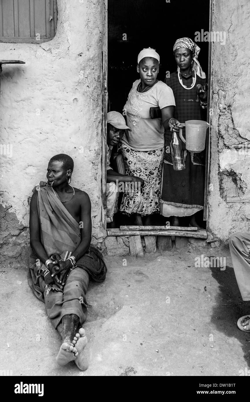 Mursi Woman Sitting Outside A House, Jinka, Omo Valley, Ethiopia Stock Photo