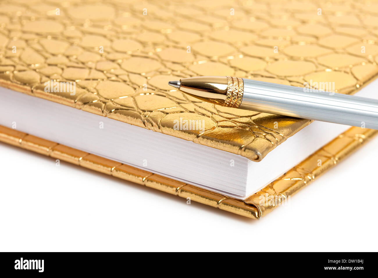 Golden notebook with silver pen Stock Photo - Alamy