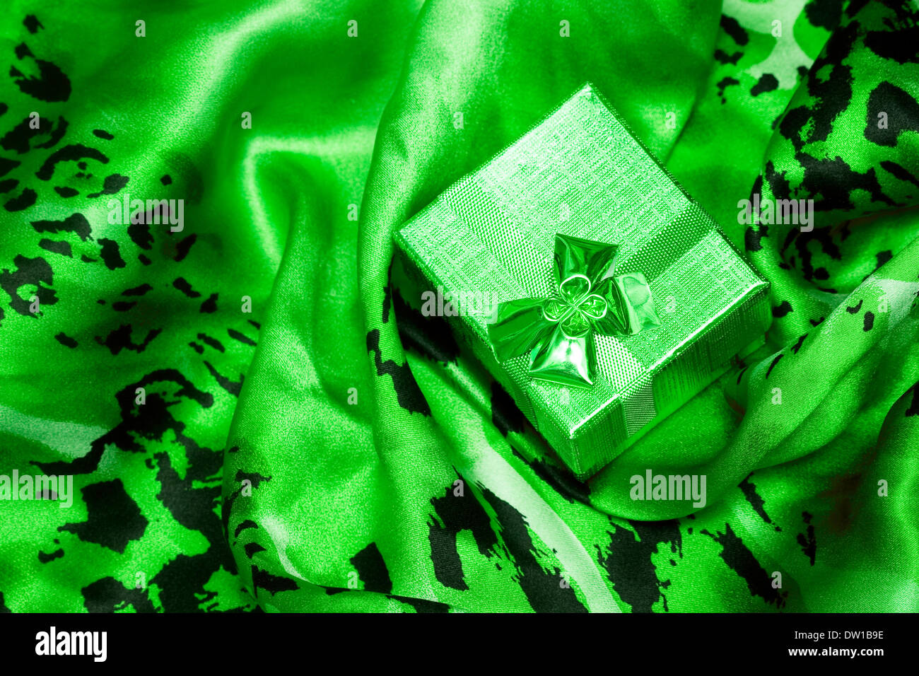 green gift box on silk background Stock Photo - Alamy