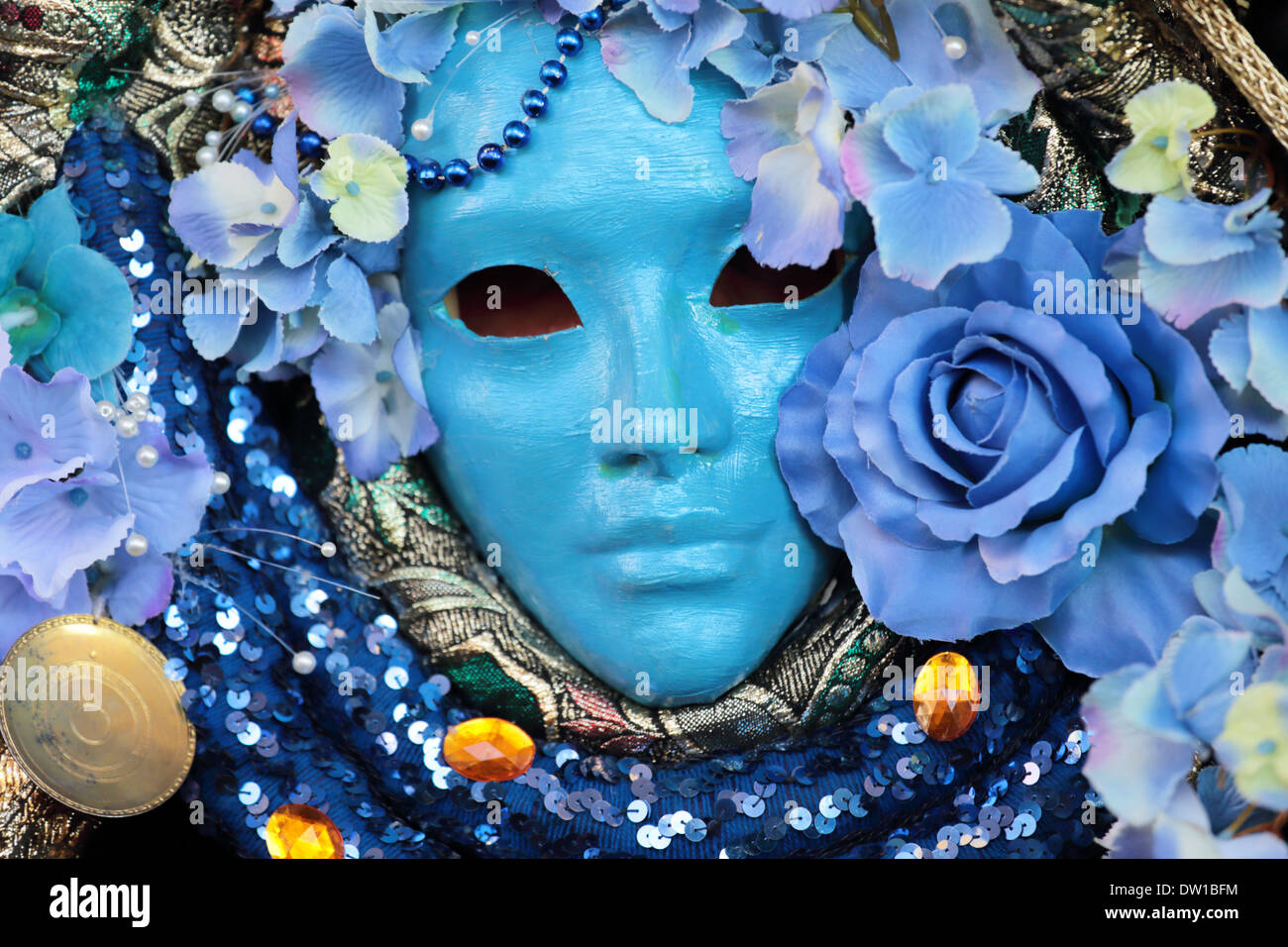 A blue mask with floral decorations exhibited during the traditional Carnival of Venice, Italy (2014 edition) Stock Photo