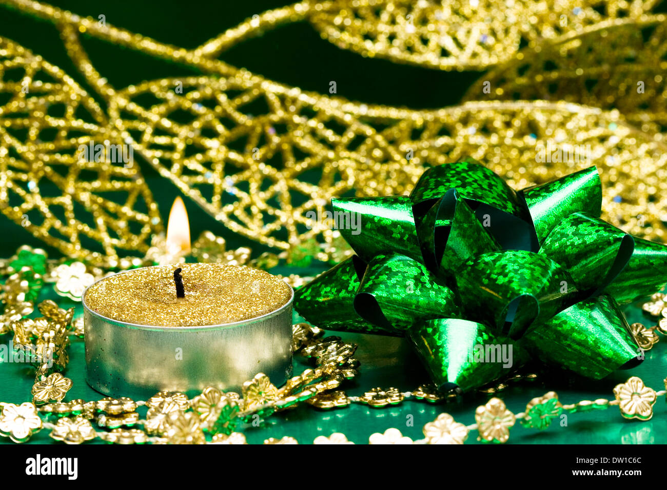 green festive bow and burning candle Stock Photo Alamy