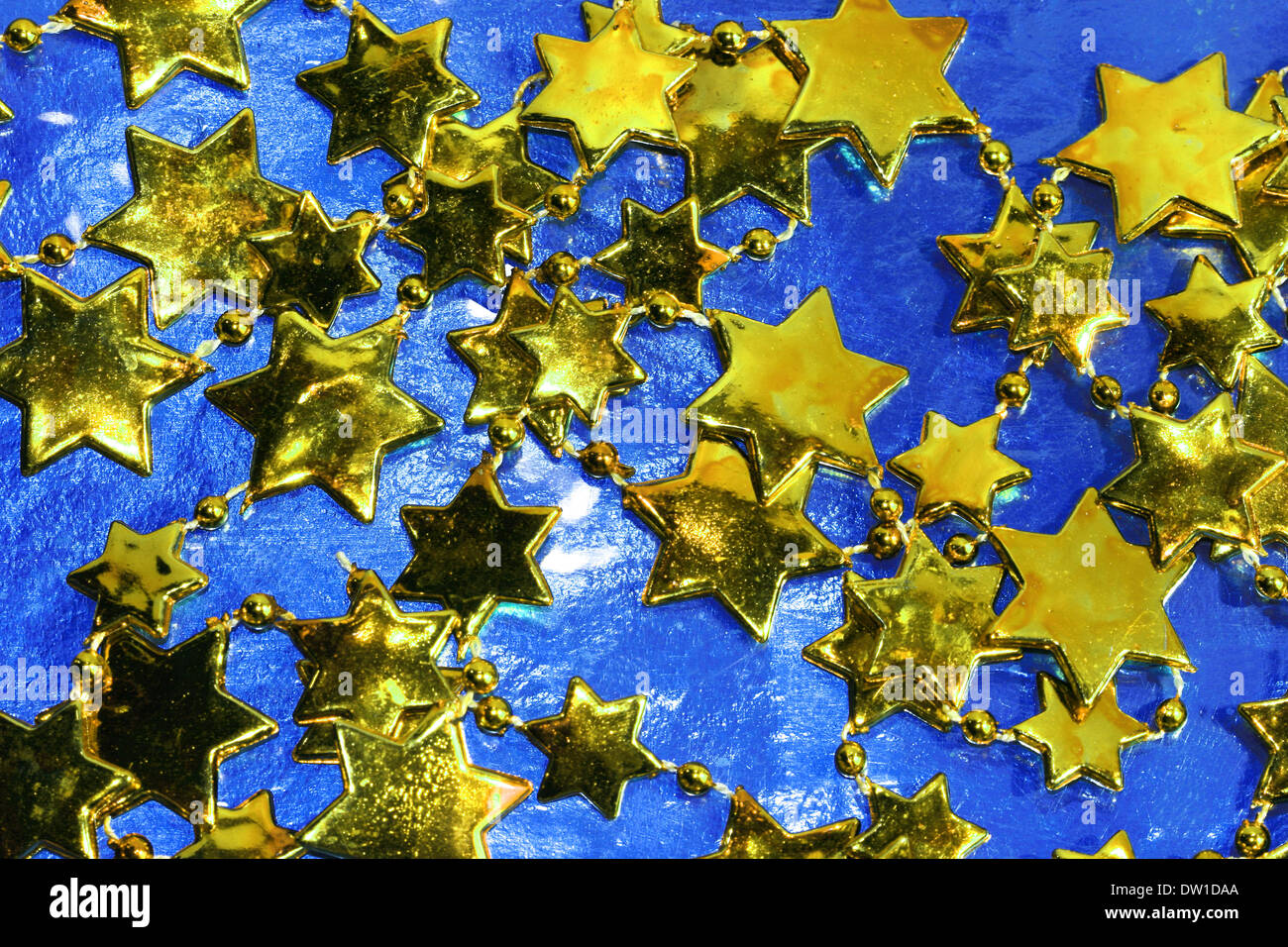 golden Christmas stars on blue background Stock Photo - Alamy