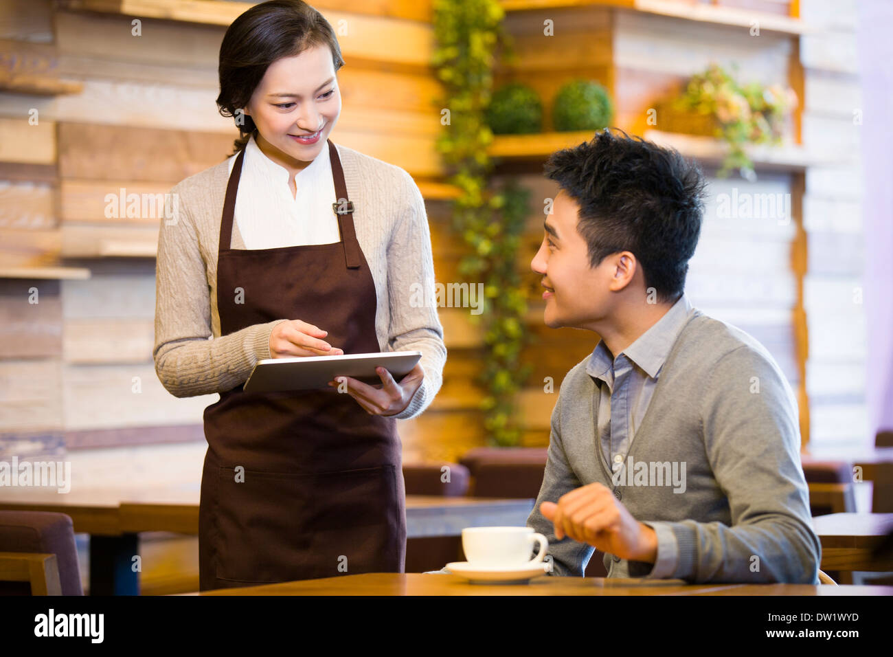 Customer using digital tablet for ordering Stock Photo