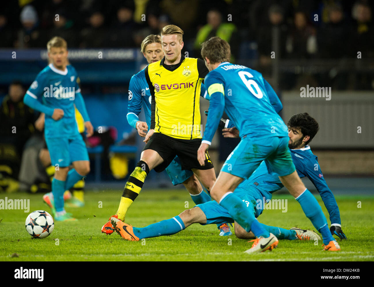 St. Peterburg, Russia. 25th Feb, 2014. Dortmund's Marco Reus (C) vies for the Ball with Zenit's Anatoliy Tymoshchuk (L-R), Nicolas Lombaerts and Luis Neto during the UEFA Champions League round of 16 first leg soccer match between Zenit St. Petersburg and Borussia Dortmund at Petrowski stadium in St. Peterburg, Russia, 25 February 2014. Borussia Dortmund are well placed to reach the quarter-finals of the Champions League after an emphatic 4-2 win at Zenit Saint Petersburg. Photo: Bernd Thissen/dpa/Alamy Live News Stock Photo