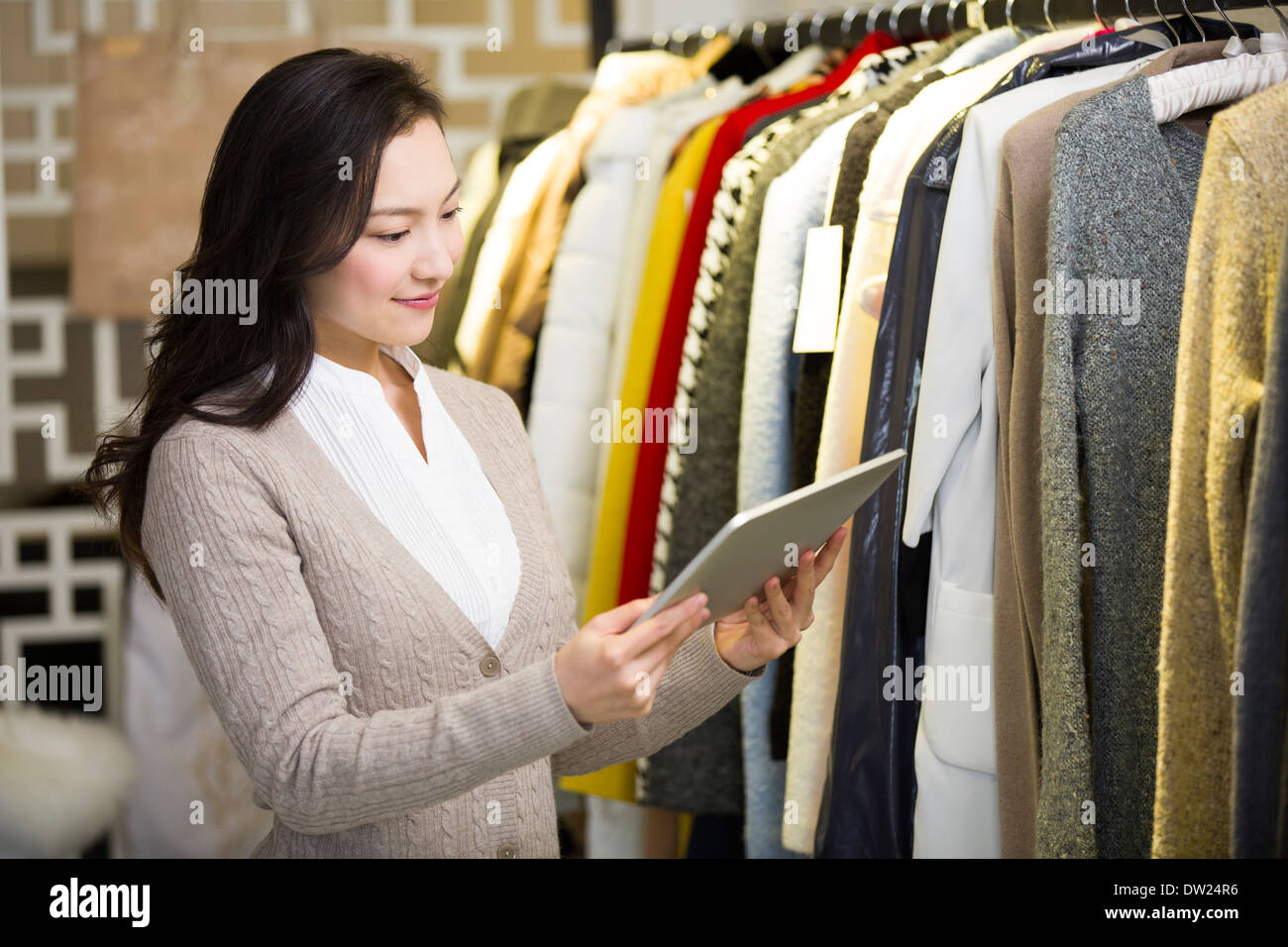 Clothing store owner with digital tablet Stock Photo