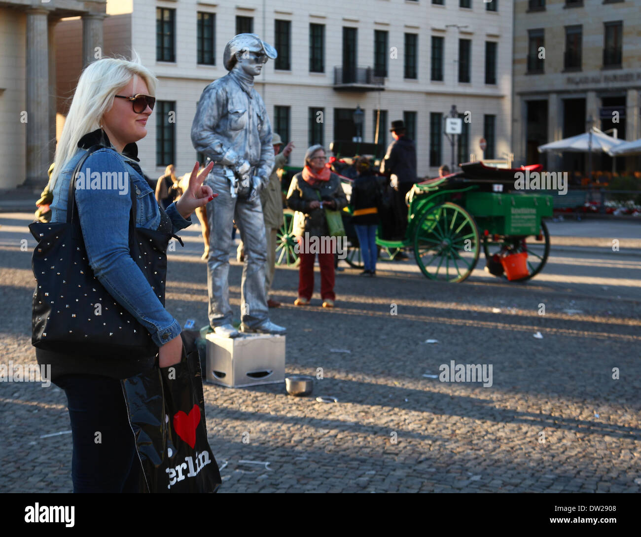 A street acrobat performs for tourists at the Brandenburg Gate in Berlin, September, 29, 2013. More and more tourists come to Berlin. The photo is part of a series on tourism in Berlin. Photo. Wolfram Steinberg dpa Stock Photo