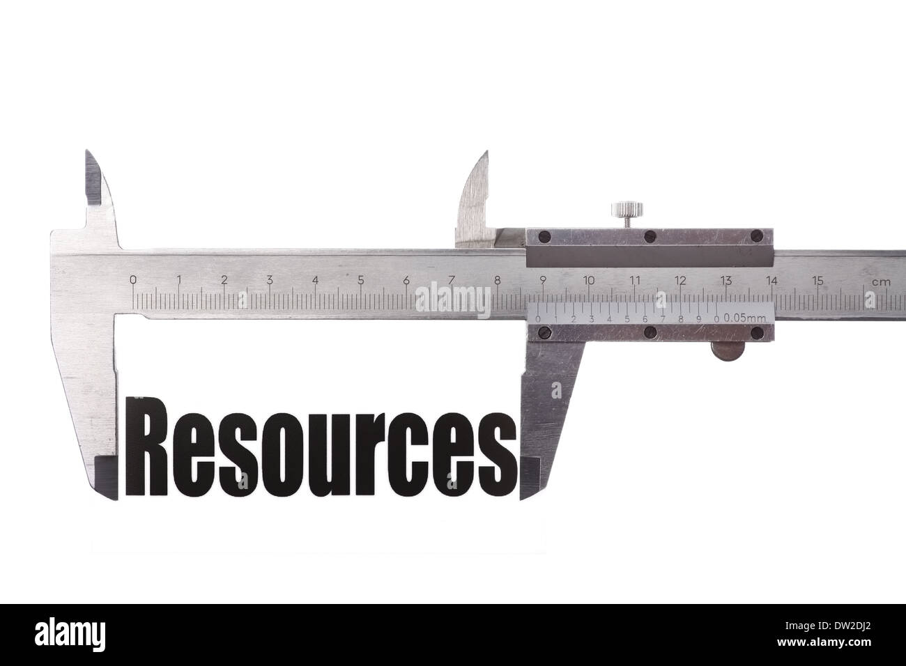 Close up shot of a caliper, measuring the word "Resources Stock Photo