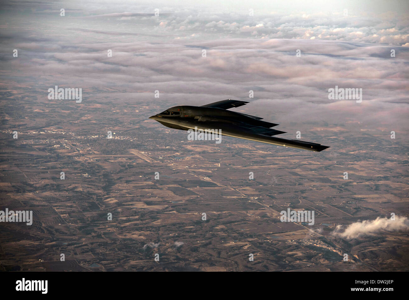 A US Air Force B-2 Spirit stealth bomber aircraft flies over Whiteman Air Force Base February 20, 2014 in Knob Noster, MO. Stock Photo