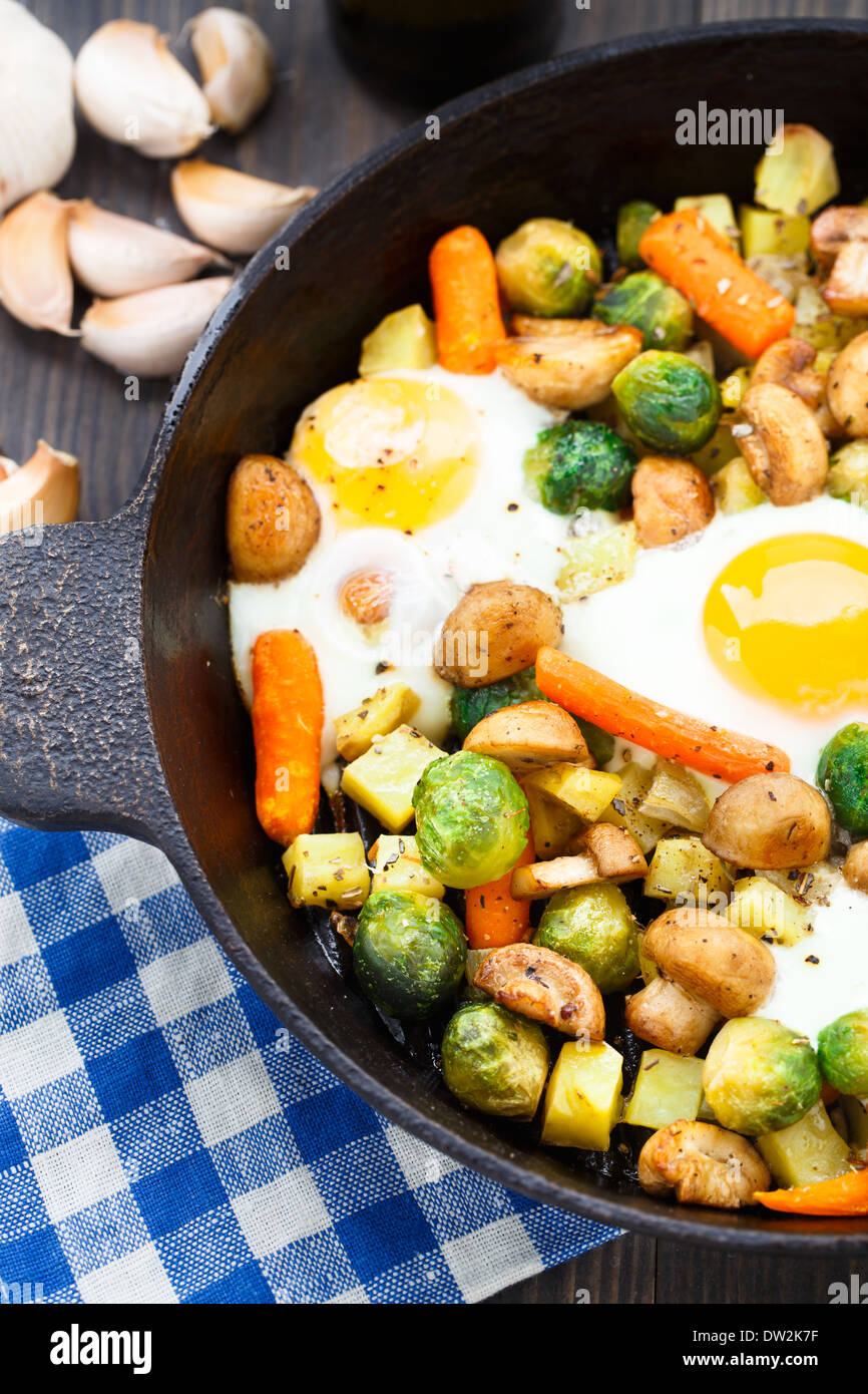 Baked eggs with vegetables and mushrooms Stock Photo