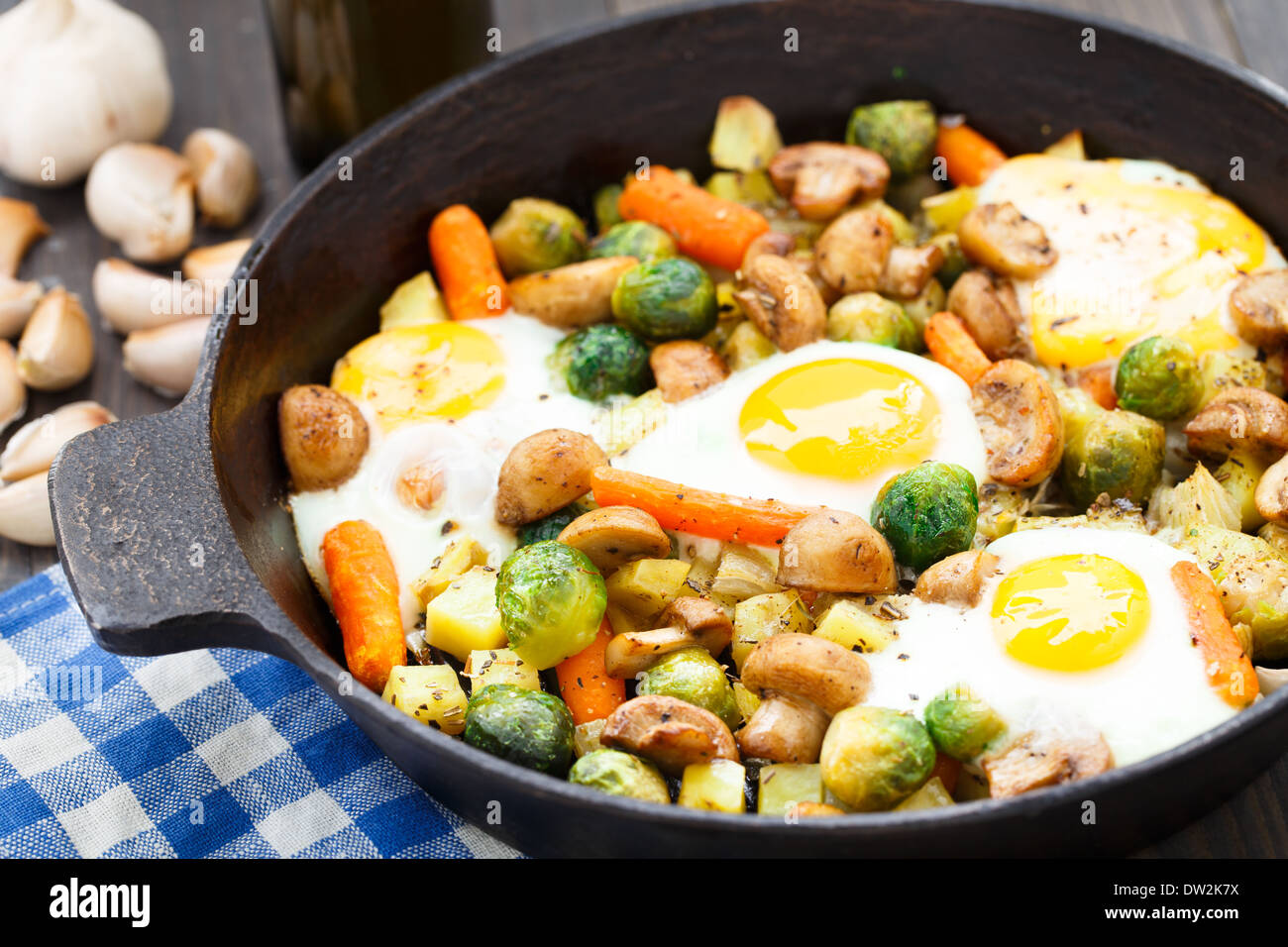 Baked eggs with vegetables and mushrooms Stock Photo