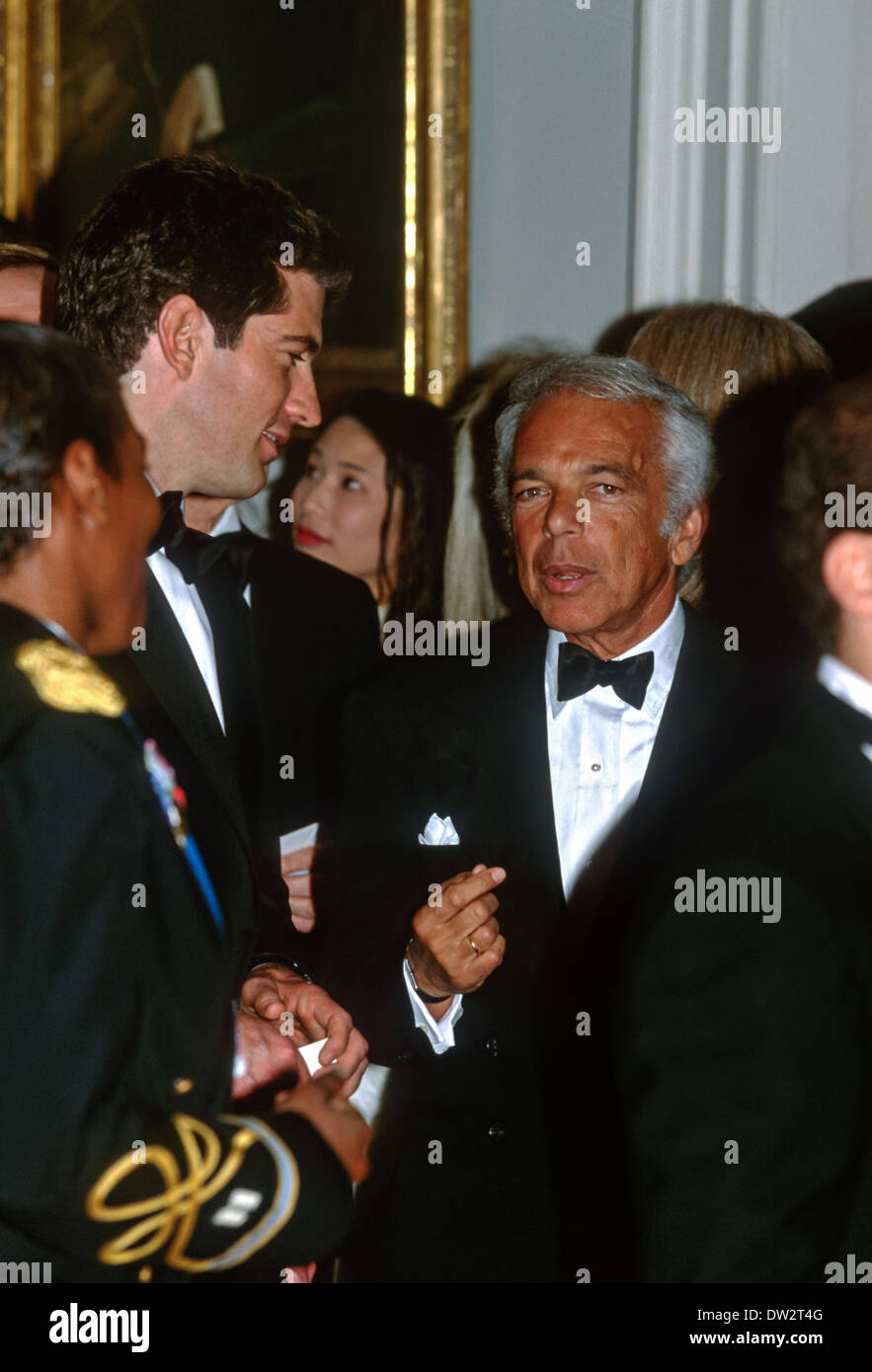 Designer Ralph Lauren speaks with John Kennedy, jr at the State Dinner for the British Prime Tony Blair Minister February 5, 1998 at the White House in Washington, DC. Stock Photo