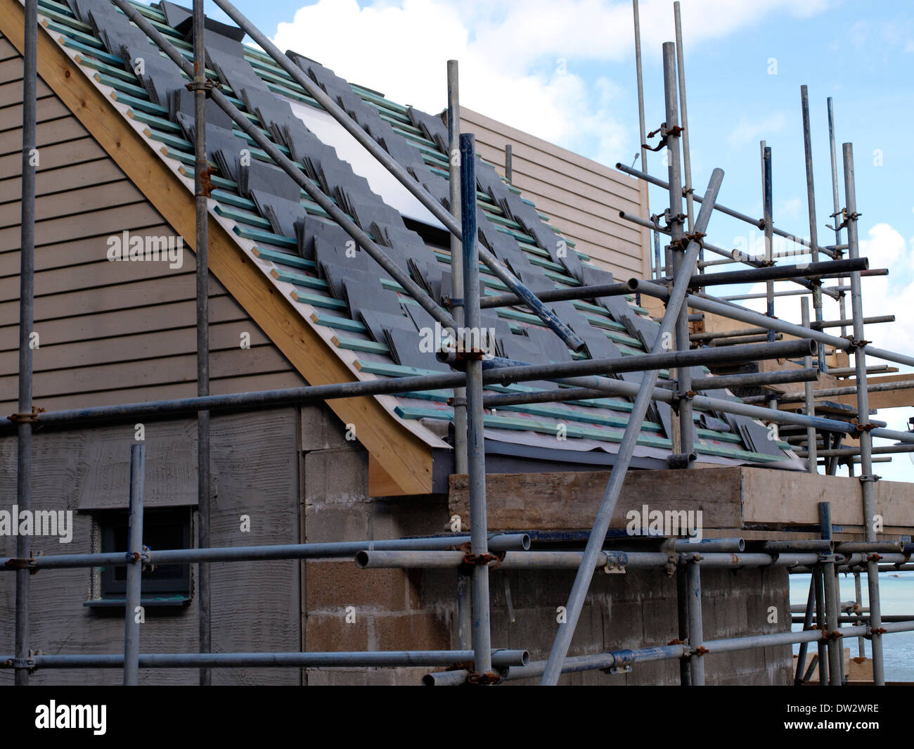Tiles stacked on new roof, New fisherman's store rooms with offices above being built, Newquay Harbour, Cornwall, UK Stock Photo