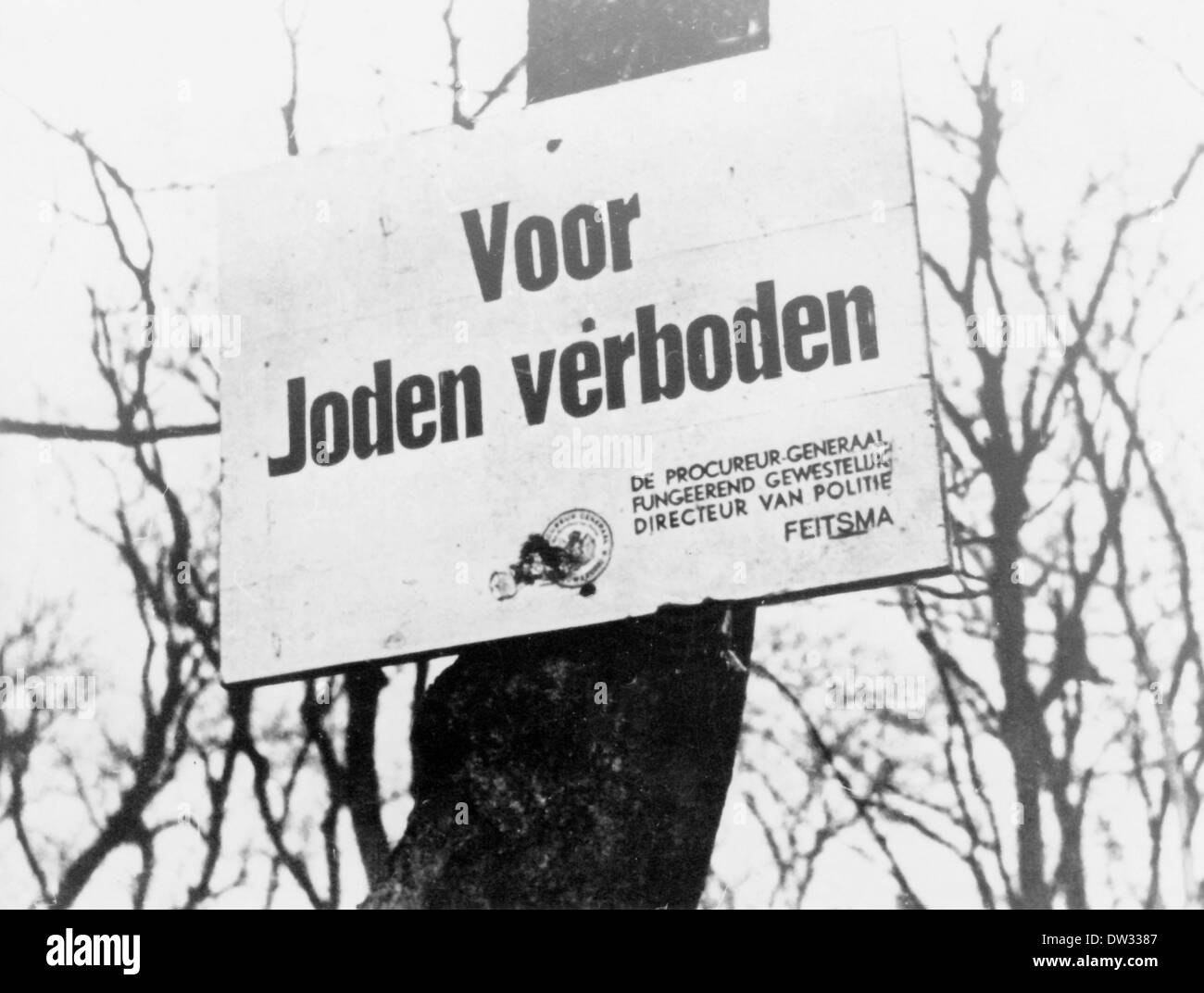 After the occupation of the Netherlands by the German Wehrmacht in 1940 a ban sign reading 'Voor Joden verboden' ('Forbidden for Jews') and signed by the Amsterdam 'procureur-generaal' (Attorney General) Jan Feitsma hangs on a tree, date and place unknown. Fotoarchiv für Zeitgeschichtee / NO WIRE SERVICE Stock Photo