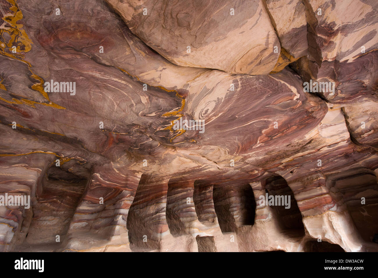Interior of a carved tomb in the Street of Façades, showing the rock formations, Petra, Jordan Stock Photo