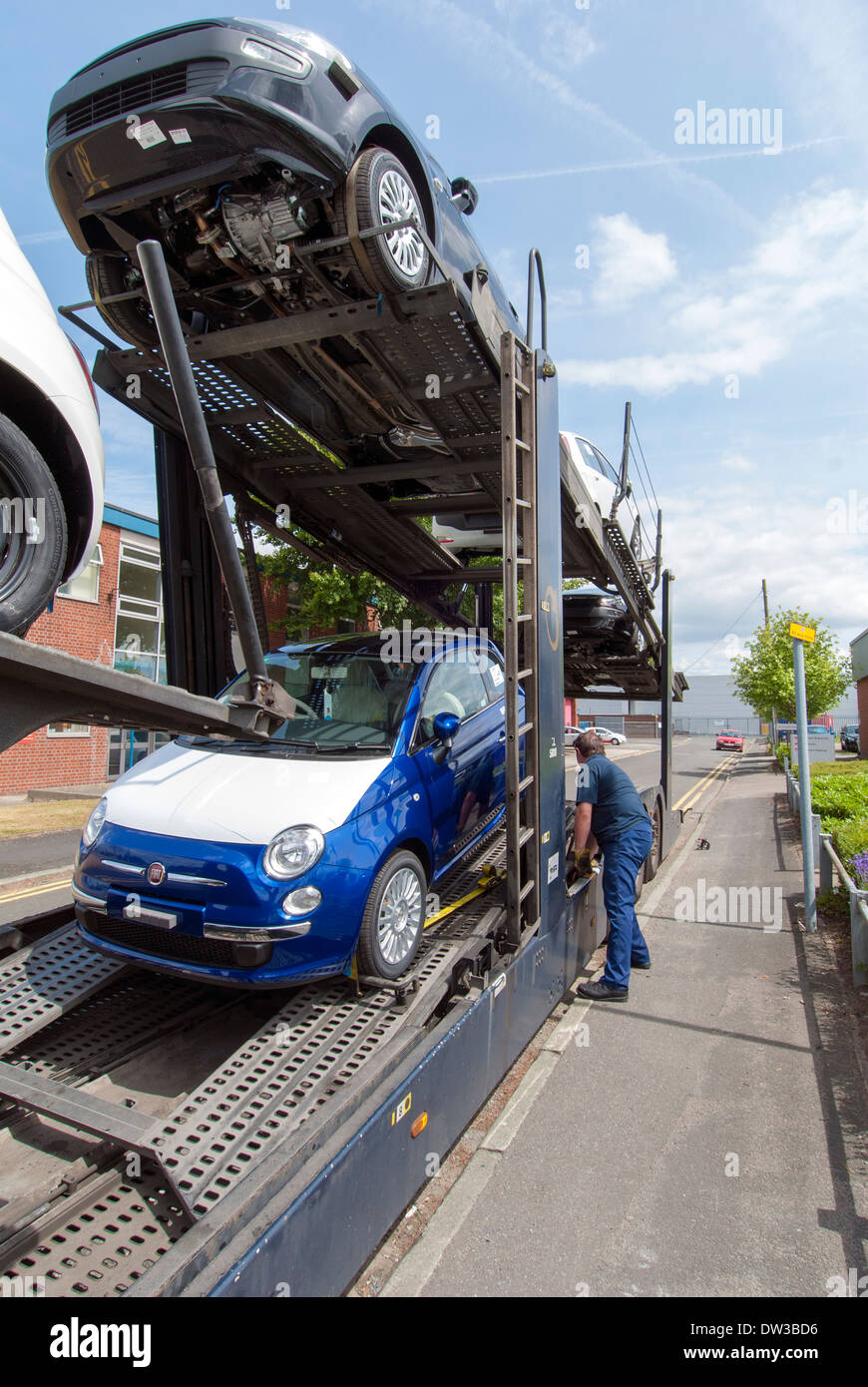 Car transporter delivering new FIAT cars to dealer, Warrington, Cheshire, UK Stock Photo
