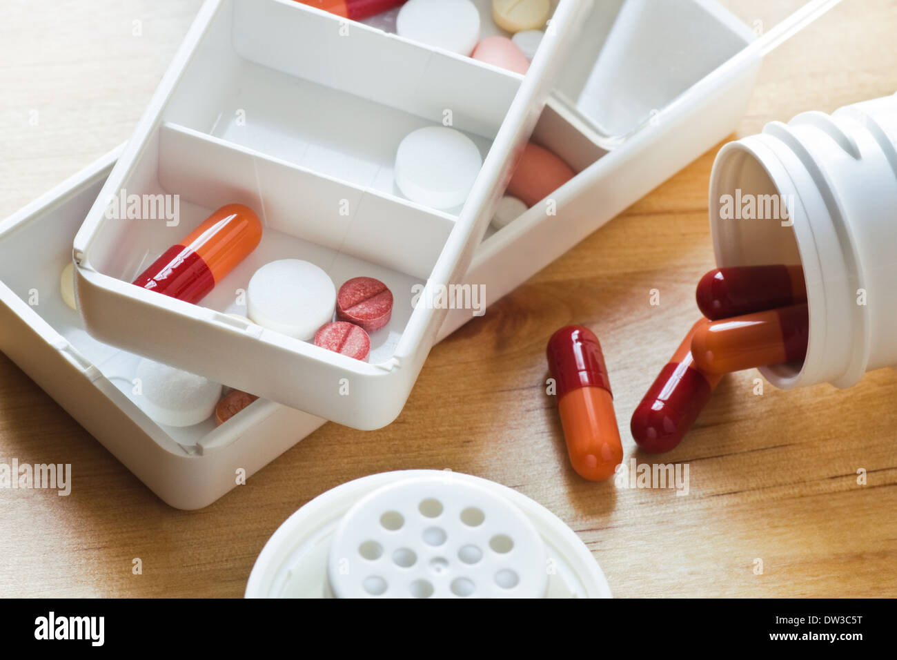 Healthcare - Daily medication - pills, tablets and capsules sorted out in pillboxes for use as daily medication Stock Photo