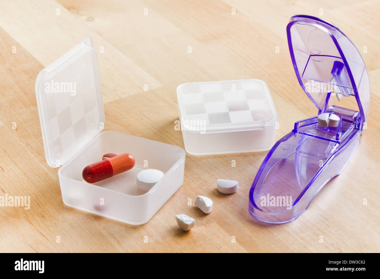 Health care - Sorting out daily medication in pillboxes using pillcutter Stock Photo
