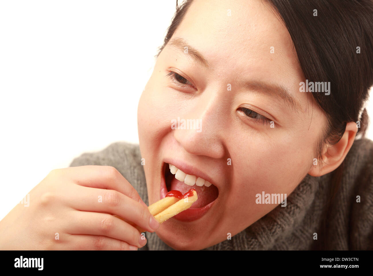 Asian woman eating  French fries on white background Stock Photo