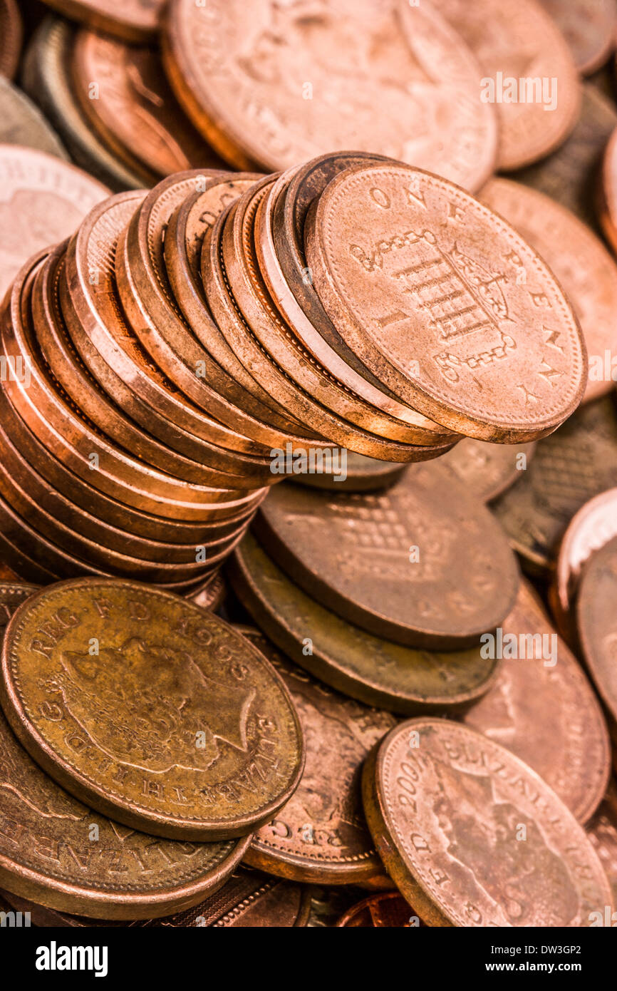 British one penny and two penny copper coins. An extreme close-up of money shot at an angle. Stock Photo
