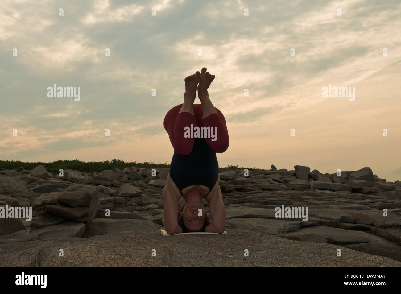 Iyengar Yoga Instructor Demonstrates Sirsasana bent leg (Inverted). Stock Photo