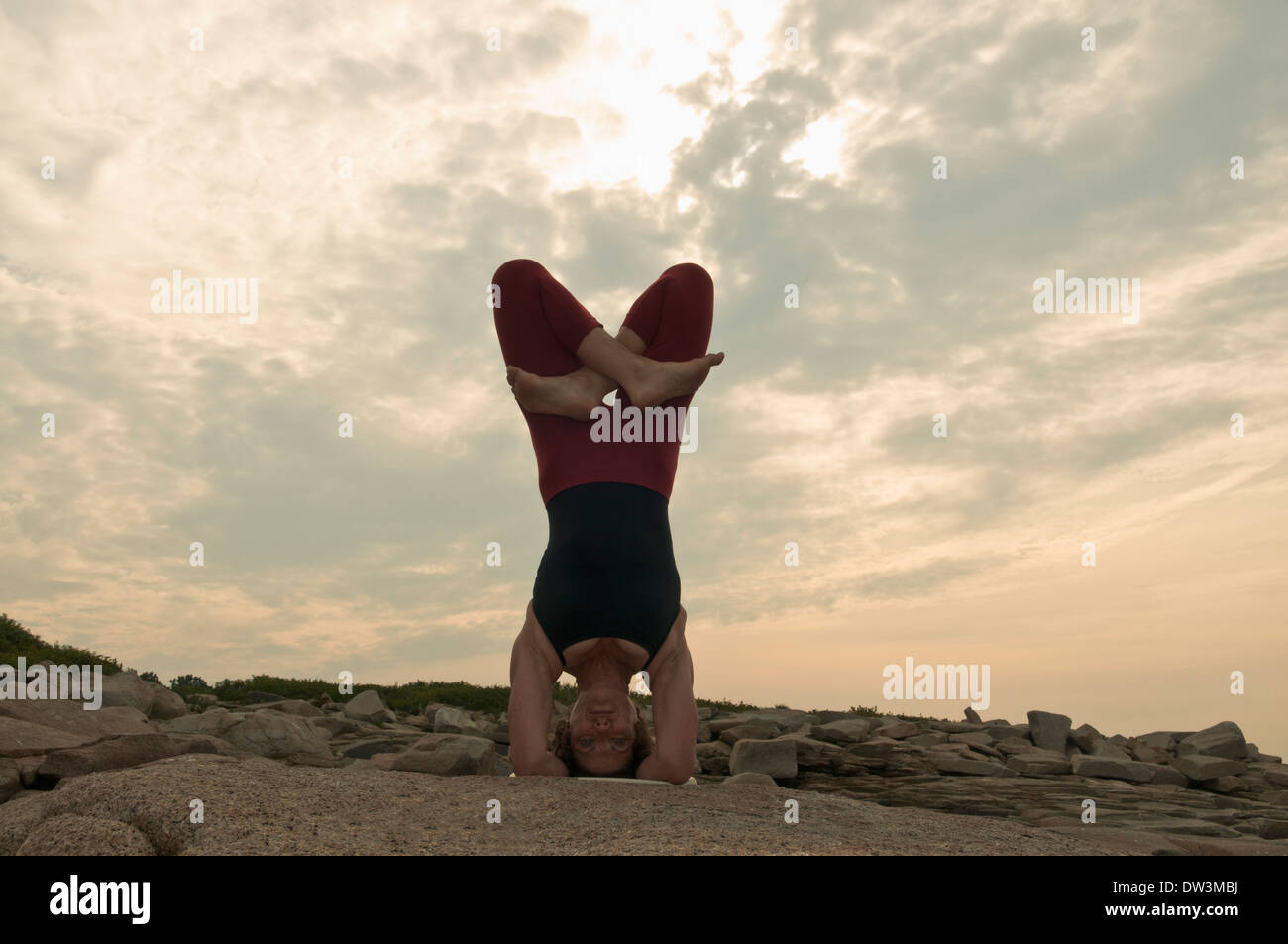 Iyengar Yoga Instructor Demonstrates Sirsasana padmasana (Inverted). Stock Photo