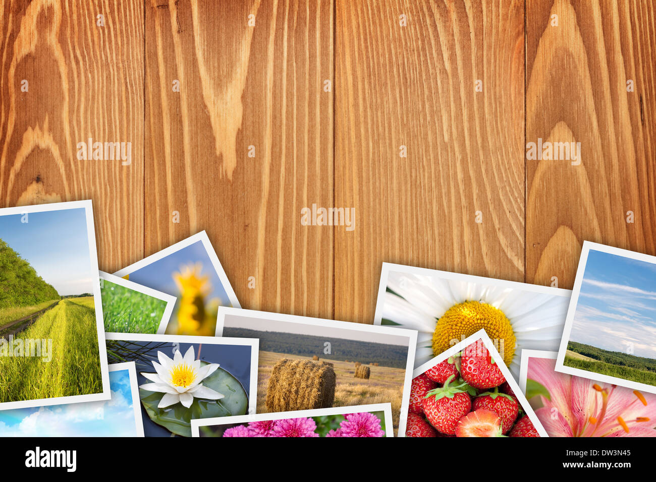 Stack of printed pictures collage on wooden table with copy space for your text or photo Stock Photo