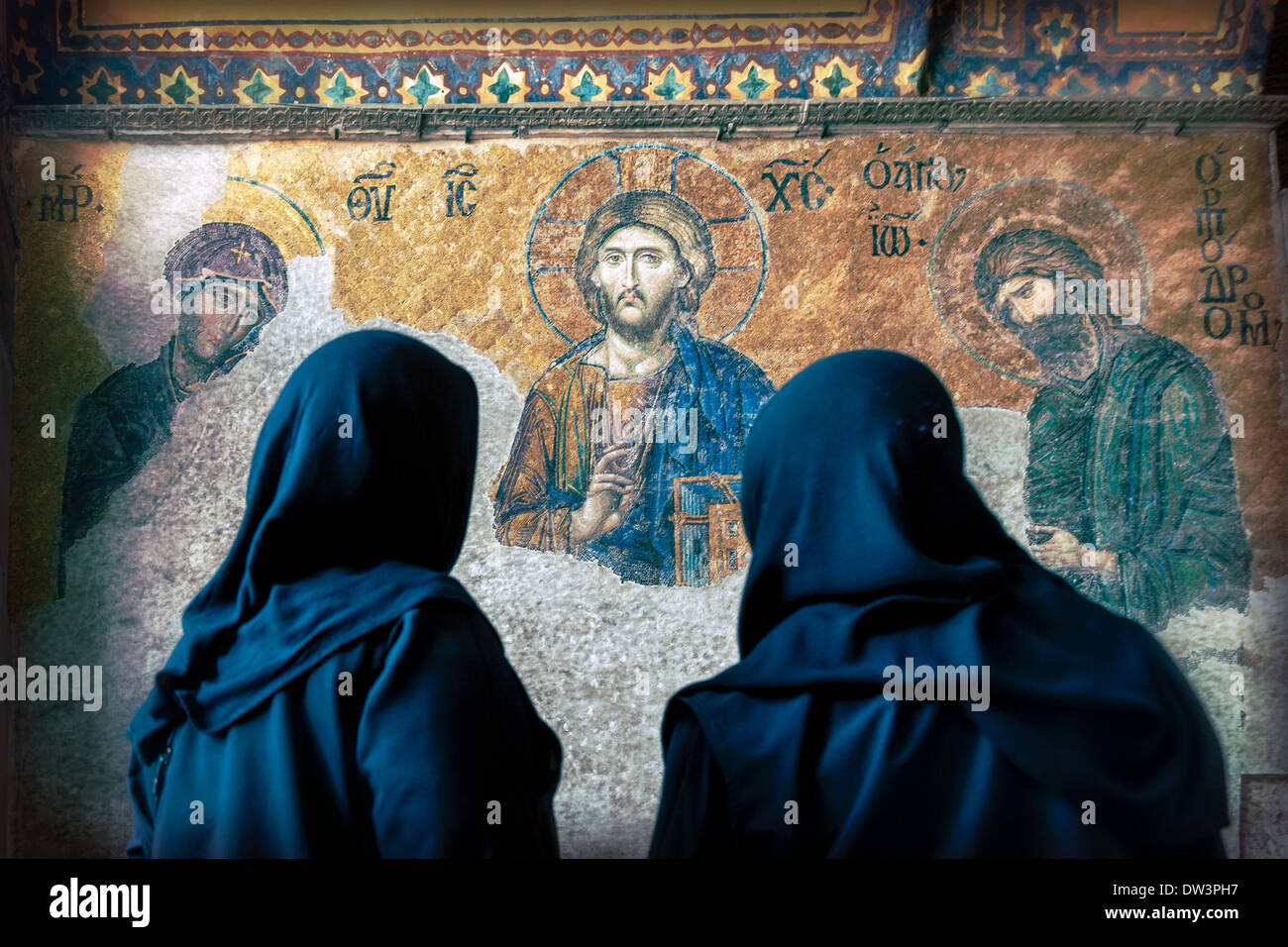 Women looking at Christ image in Hagia Sophia in Istanbul Turkey. Stock Photo