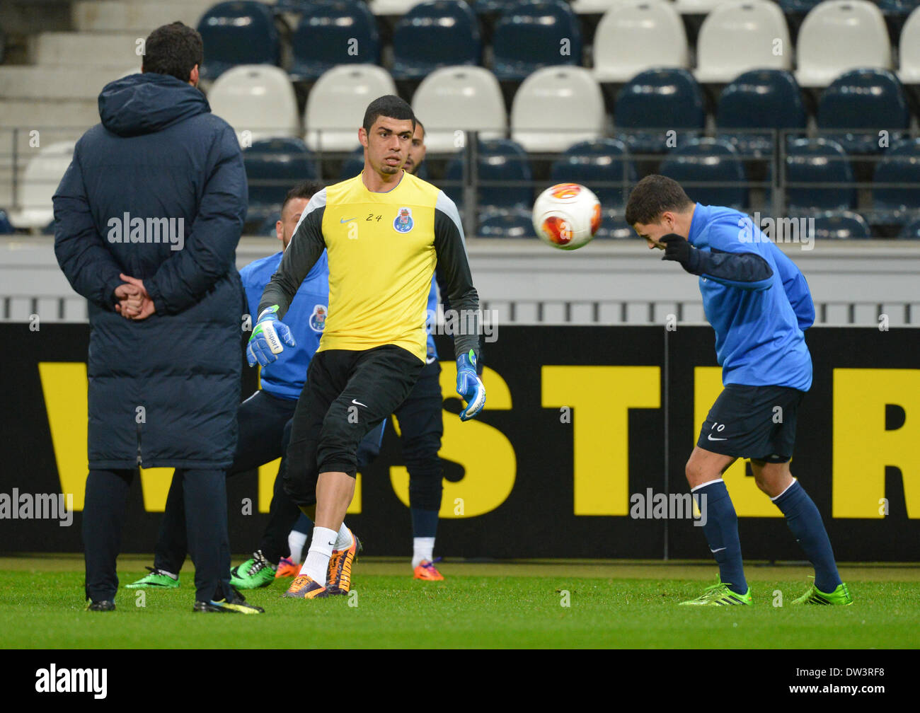 Frankfurt, Germany. 27th Feb, 2014. Porto's Juan Quintero (r) heads the ball next to goalkeeper Fabiano (c) and head coach Paulo Fonseca during a practise at Frankfurt Stadium in Frankfurt, Germany, 27 February 2014. FC Porto will play against Eintracht Frankfurt in the UEFA Europa League round of 32 second leg soccer match on Thursday. Photo: Arne Dedert/dpa/Alamy Live News Stock Photo