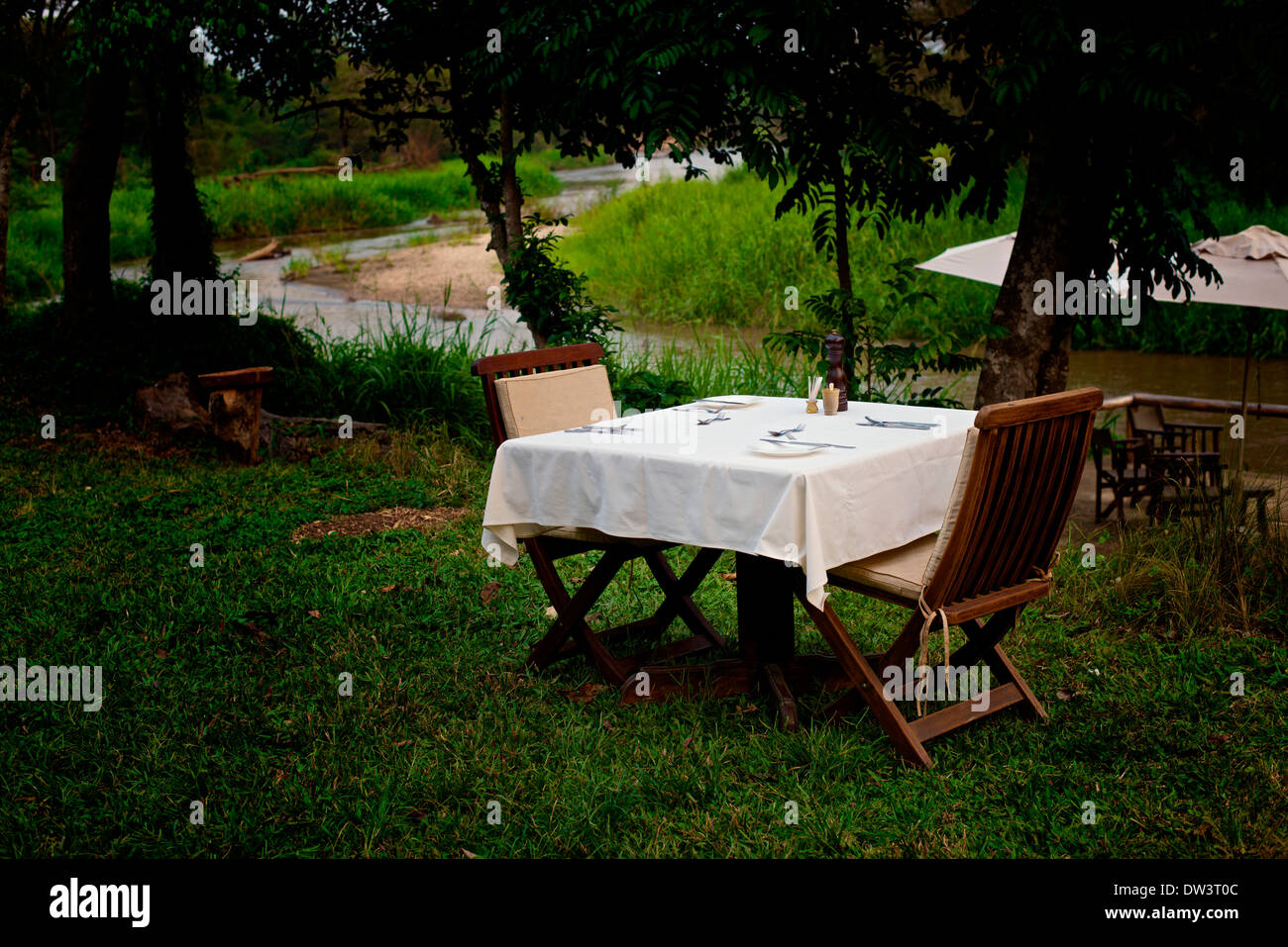 Dining Al Fresco - A dinner setting for two 2 outdoors in the Ugandan evening. Stock Photo