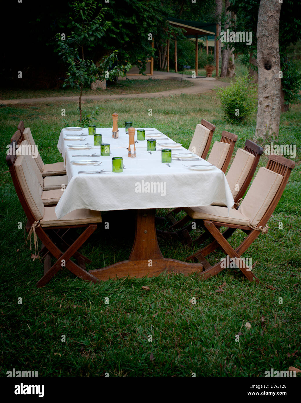 Al Fresco Dining - Seating for eight 8 outdoors in the Ugandan evening in a grassy area. Stock Photo