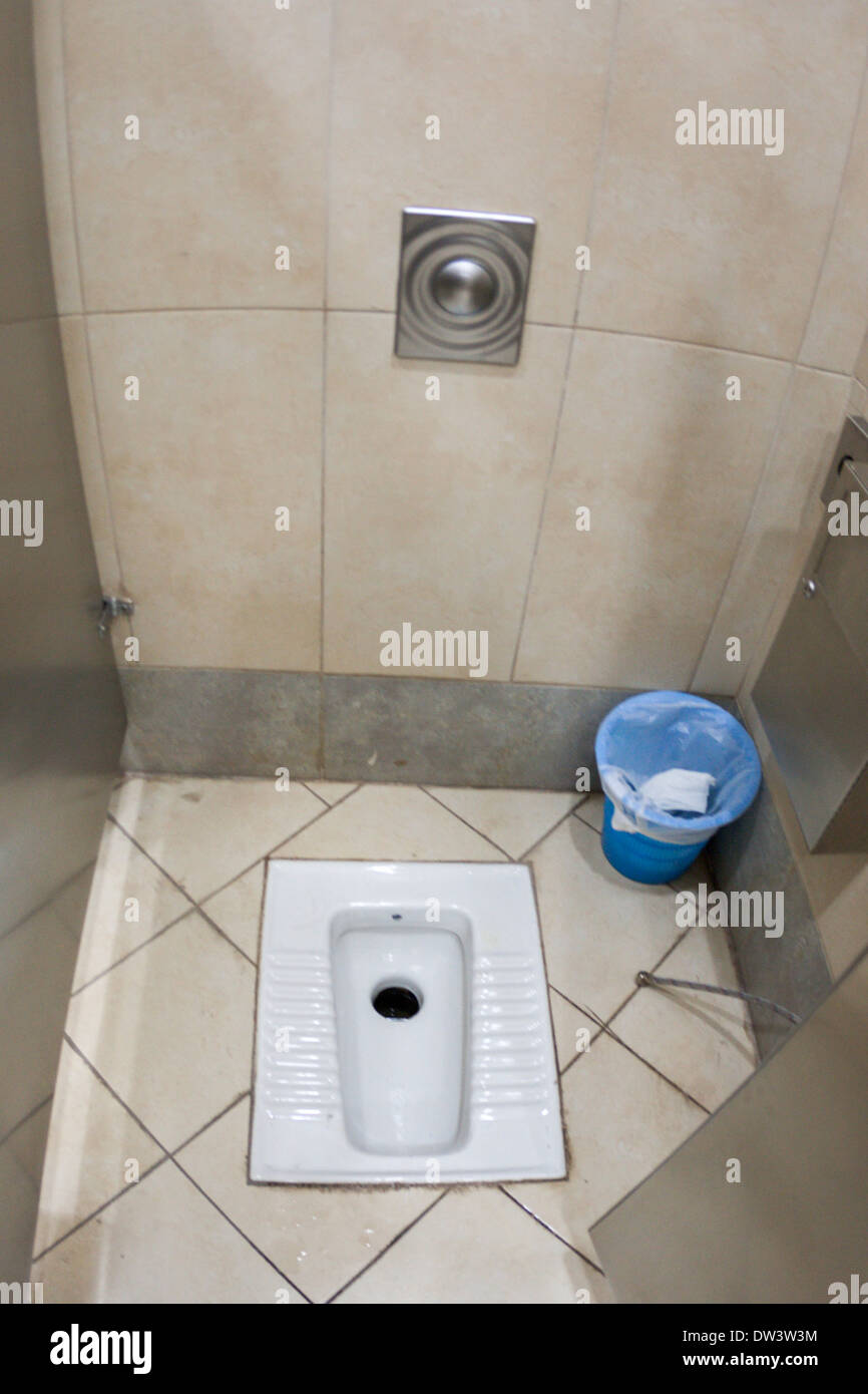 Middle-eastern toilet in the floor of the rest room of the Beirut–Rafic Hariri International Airport in Beirut, Lebanon. Stock Photo
