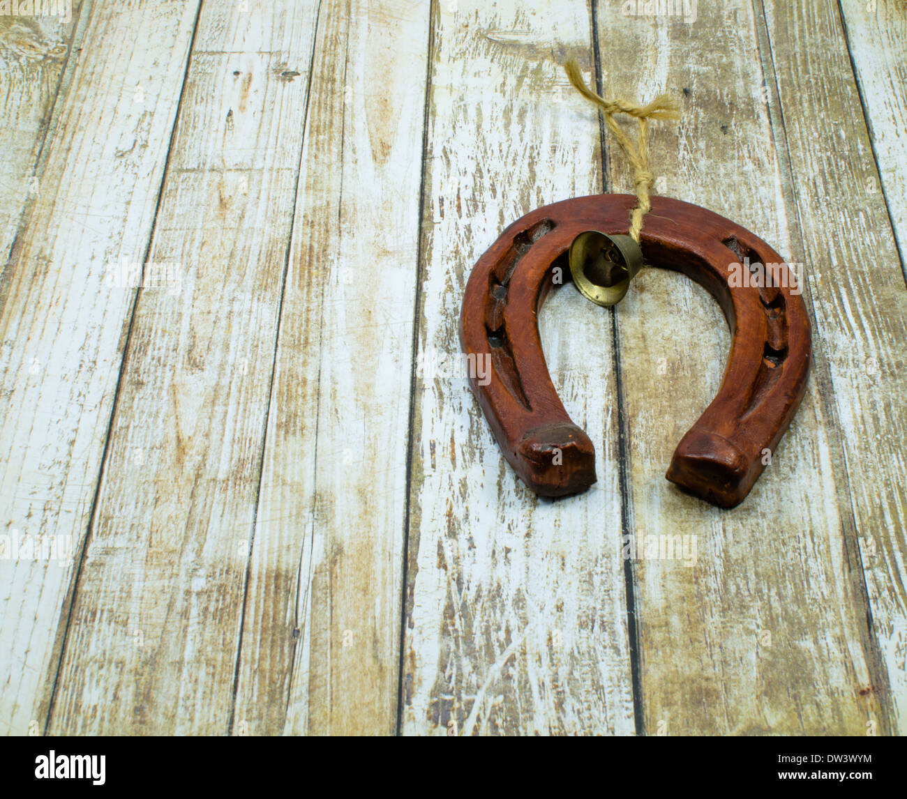 Horseshoe and two horseshoe nails on wooden plank Stock Photo - Alamy