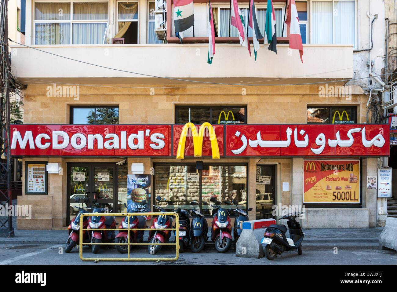 McDonald's with sign in Arabic and delivery motorcycles in front in